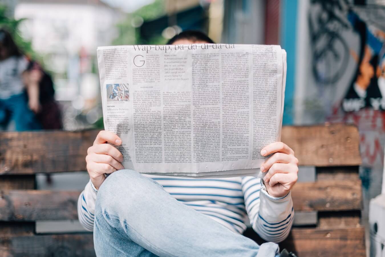 woman reading newspaper